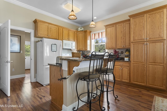 5200 W Beach Blvd, Gulfport, MS 39501 - kitchen featuring white appliances, dark wood-type flooring, a breakfast bar area, a center island, and crown molding