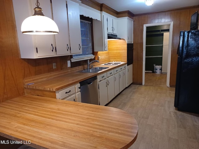 kitchen featuring white cabinetry, pendant lighting, stainless steel dishwasher, and black refrigerator