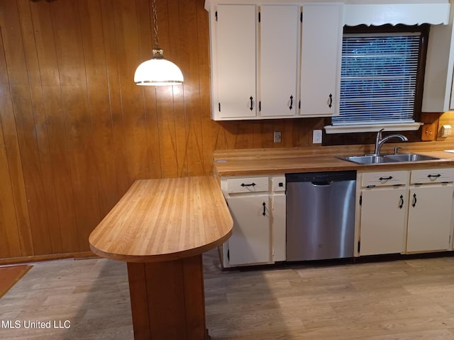 kitchen featuring decorative light fixtures, sink, white cabinetry, and dishwasher