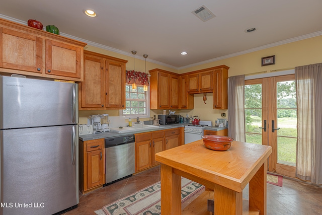 kitchen featuring ornamental molding, a healthy amount of sunlight, stainless steel appliances, and pendant lighting