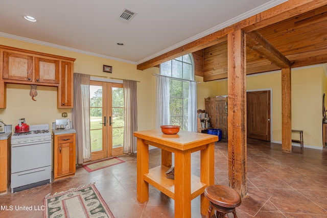3775 Coker Rd, Madison, MS 39110 - kitchen featuring white gas range, french doors, light countertops, crown molding, and brown cabinetry