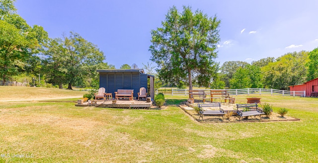 view of yard with a rural view and a wooden deck