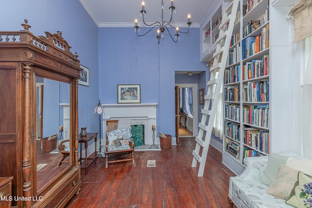 living area with an inviting chandelier, ornamental molding, and dark hardwood / wood-style flooring