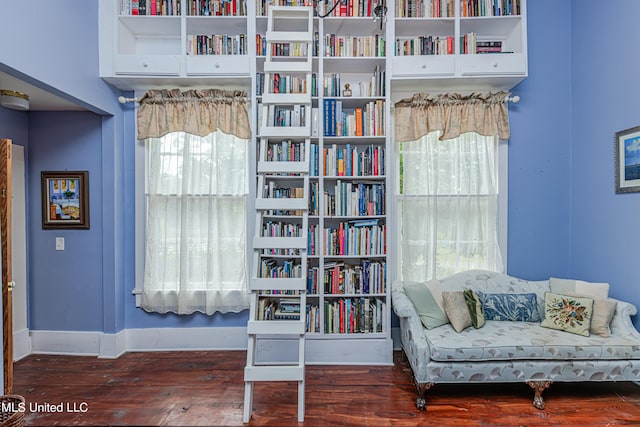 sitting room with a wealth of natural light and dark wood-type flooring