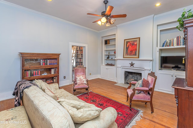 3775 Coker Rd, Madison, MS 39110 - living room featuring ornamental molding, built in features, baseboards, ceiling fan, and a fireplace with flush hearth