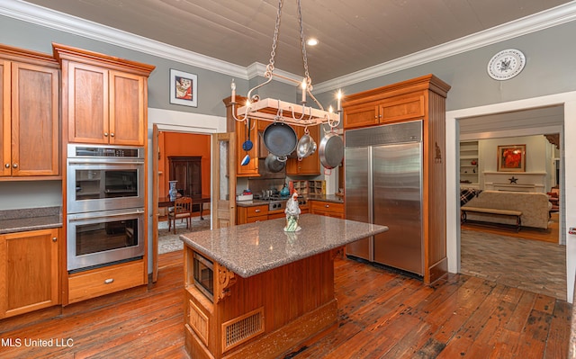 3775 Coker Rd, Madison, MS 39110 - kitchen featuring built in appliances, crown molding, dark wood finished floors, and brown cabinetry