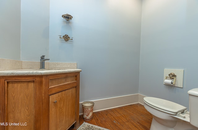 bathroom with vanity, wood-type flooring, and toilet