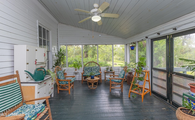 sunroom featuring vaulted ceiling, wood ceiling, and ceiling fan