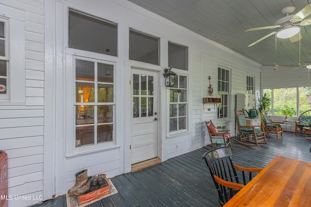 wooden terrace with a porch and ceiling fan