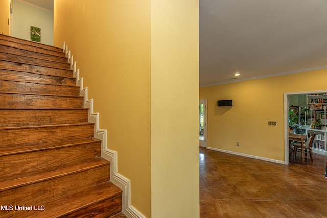 stairway with ornamental molding and tile patterned floors