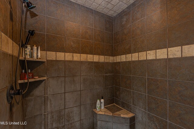 bathroom with a tile shower