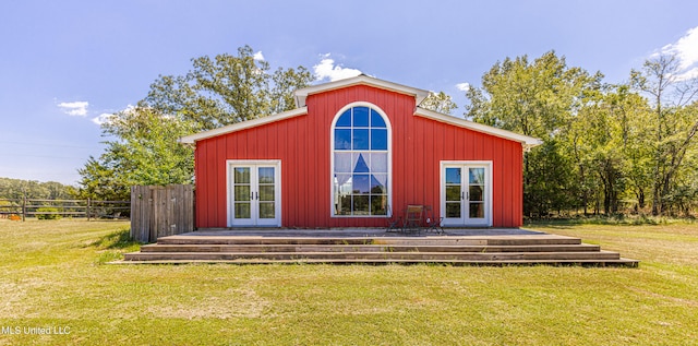 view of outdoor structure featuring french doors and a yard