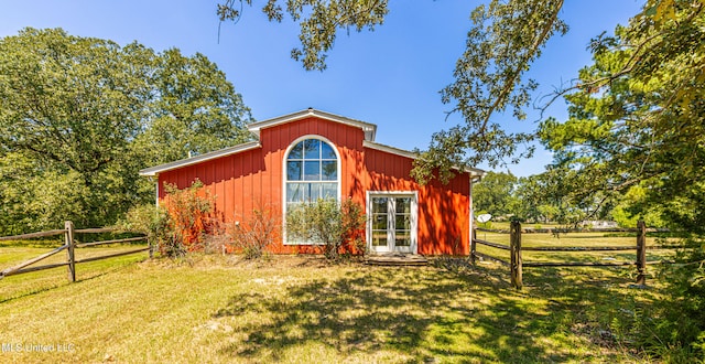 view of outbuilding featuring a lawn