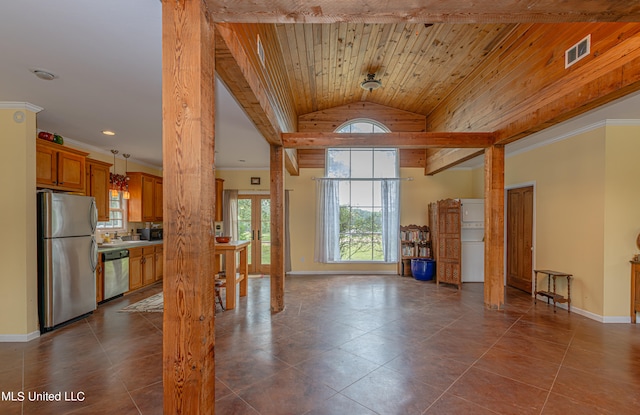 interior space featuring dark tile patterned flooring, wood ceiling, sink, and vaulted ceiling with beams