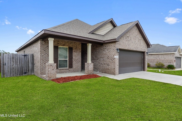 view of front of property featuring covered porch, a garage, and a front yard