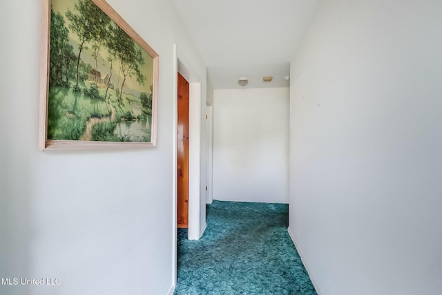 hall featuring dark colored carpet