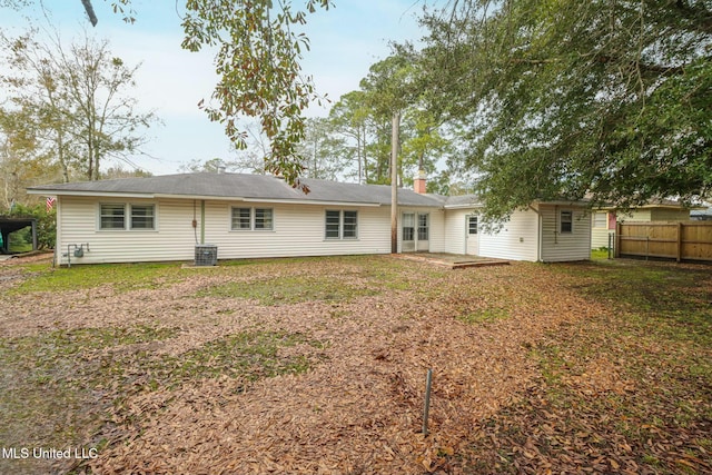 rear view of property featuring a lawn