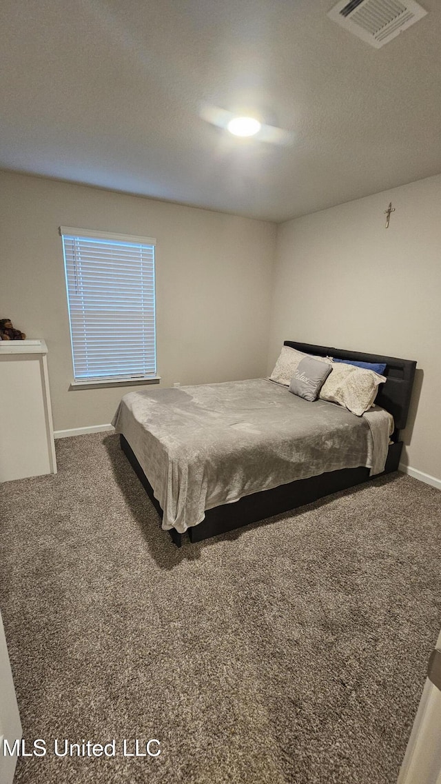 bedroom featuring visible vents, carpet, and baseboards