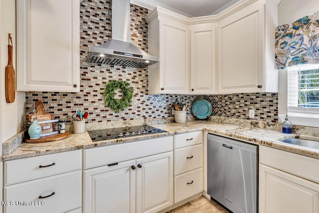 kitchen featuring wall chimney exhaust hood, white cabinets, backsplash, stainless steel dishwasher, and black electric stovetop