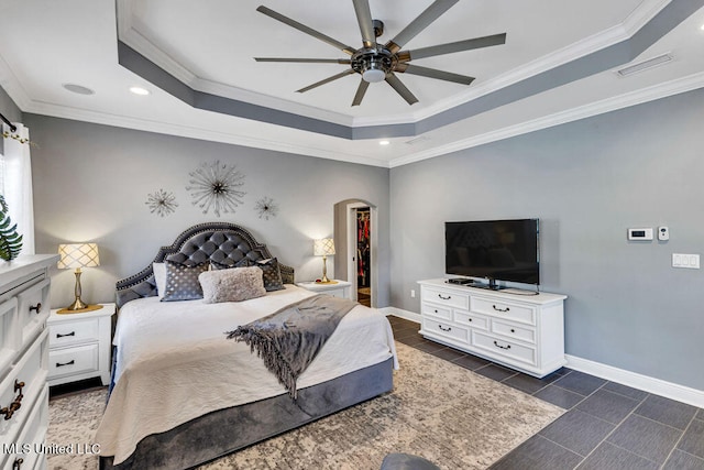 tiled bedroom featuring ornamental molding, a raised ceiling, and ceiling fan