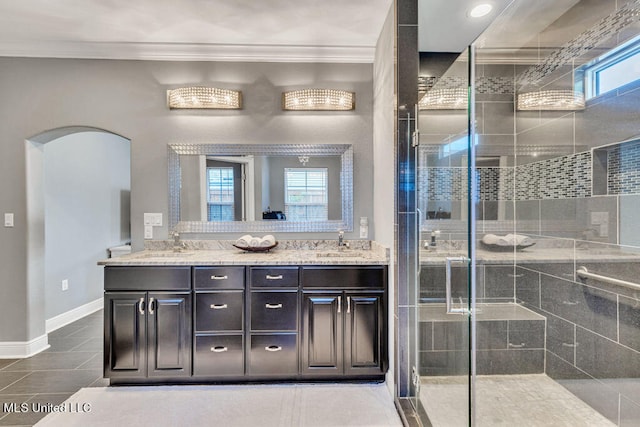 bathroom with vanity, an enclosed shower, tile patterned flooring, and crown molding