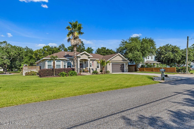 ranch-style home featuring a front yard and a garage