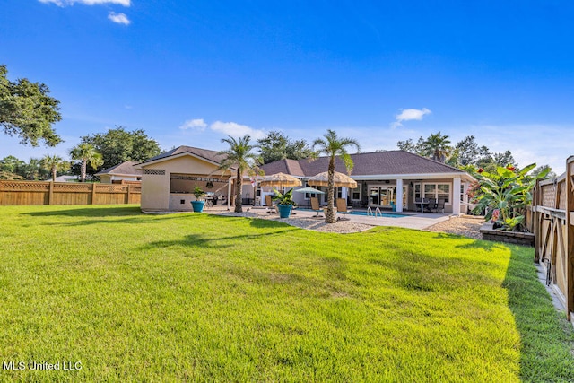 rear view of property with a patio and a yard