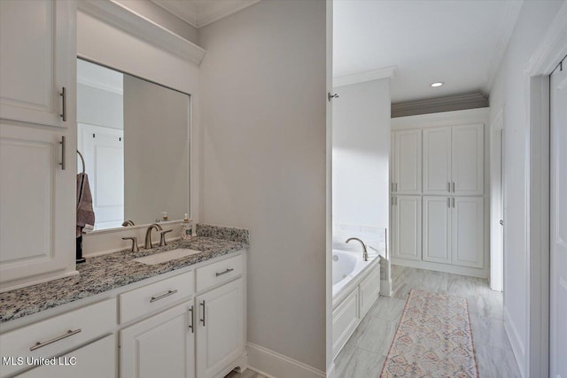 bathroom featuring vanity, a bath, and crown molding