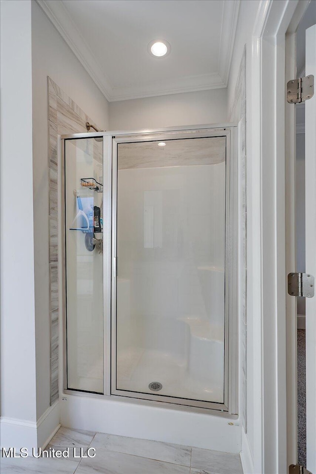 bathroom featuring walk in shower and ornamental molding