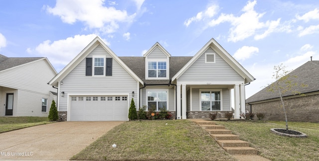 view of front of home with a front lawn, a garage, and driveway