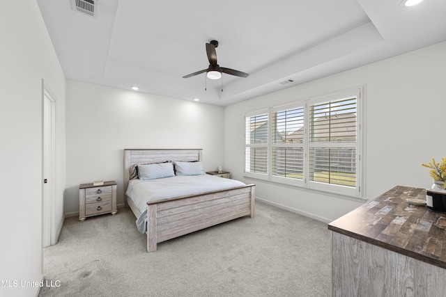 bedroom featuring a raised ceiling, carpet flooring, and visible vents