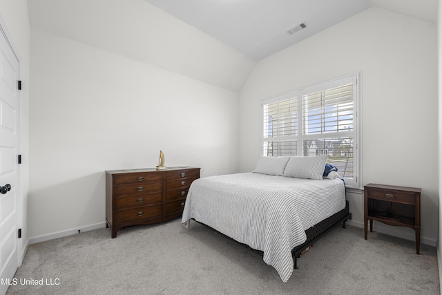 bedroom with light carpet, visible vents, baseboards, and vaulted ceiling