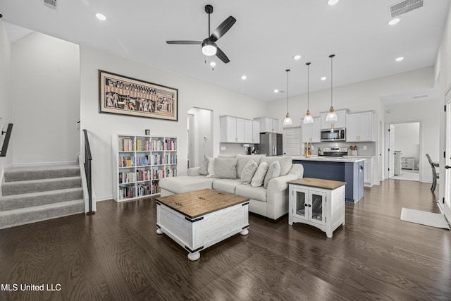 living room featuring recessed lighting, stairs, visible vents, dark wood finished floors, and ceiling fan