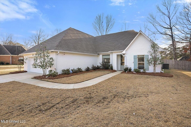 view of front of home with central AC, a front lawn, and a garage