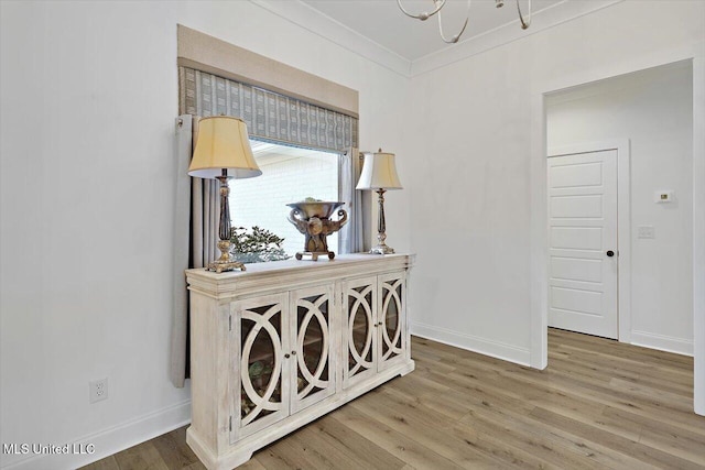 hallway with crown molding and wood-type flooring