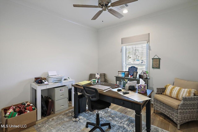 home office featuring ceiling fan, ornamental molding, and light hardwood / wood-style flooring