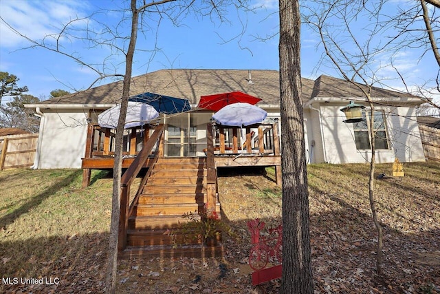 back of house with a gazebo, a deck, and a lawn