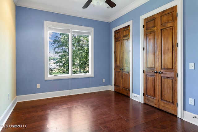 unfurnished bedroom featuring crown molding, dark hardwood / wood-style floors, and ceiling fan