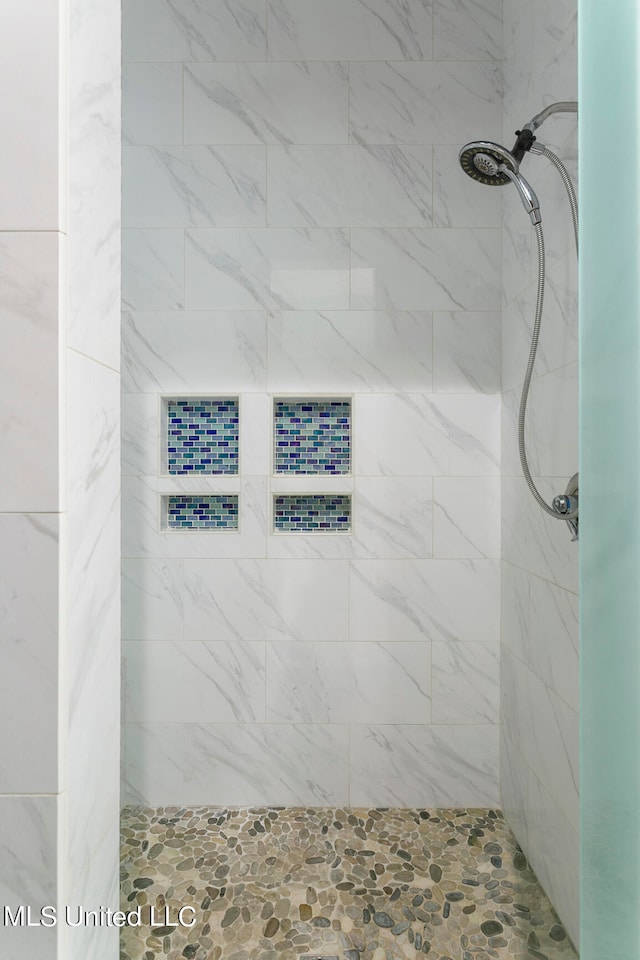 bathroom with tiled shower