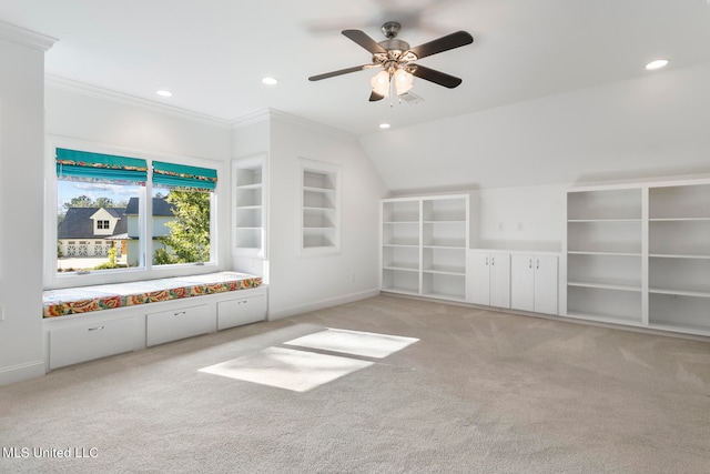 unfurnished living room featuring built in shelves, crown molding, light colored carpet, and ceiling fan