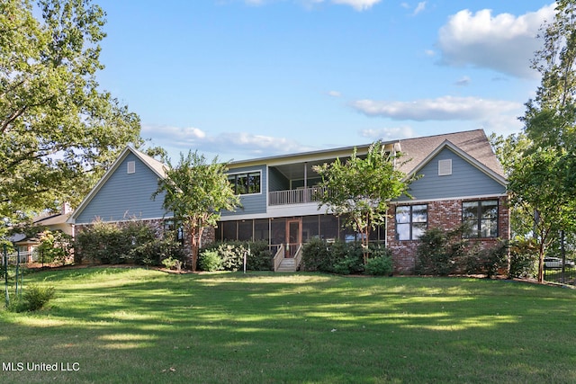 view of front of home with a sunroom and a front yard