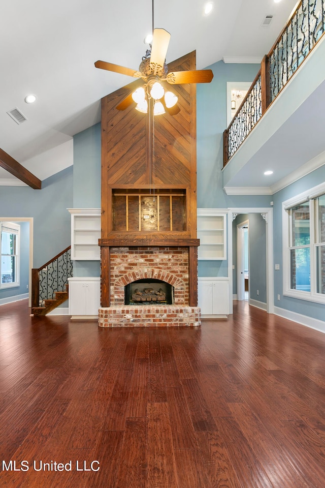 unfurnished living room with ornamental molding, hardwood / wood-style floors, a fireplace, high vaulted ceiling, and ceiling fan