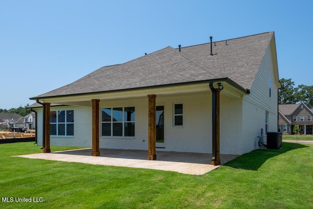 back of property featuring central AC, a yard, and a patio