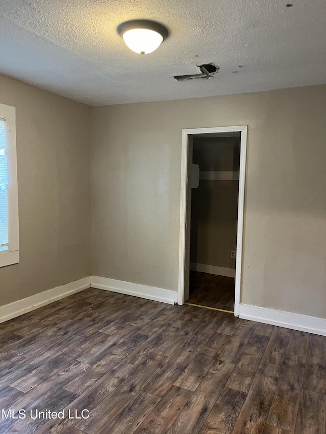 2115 Powers Ave, Jackson, MS 39213 - spare room with dark wood-style floors and a textured ceiling