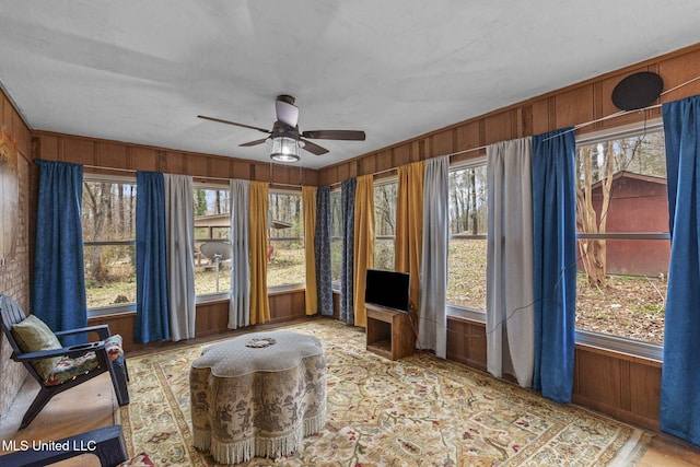 sunroom with a ceiling fan and a healthy amount of sunlight