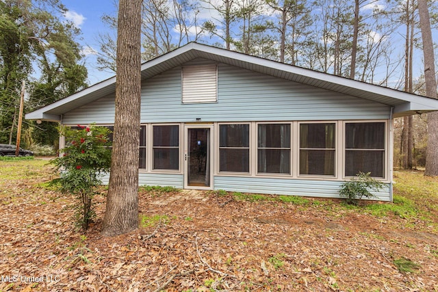 rear view of property with a sunroom