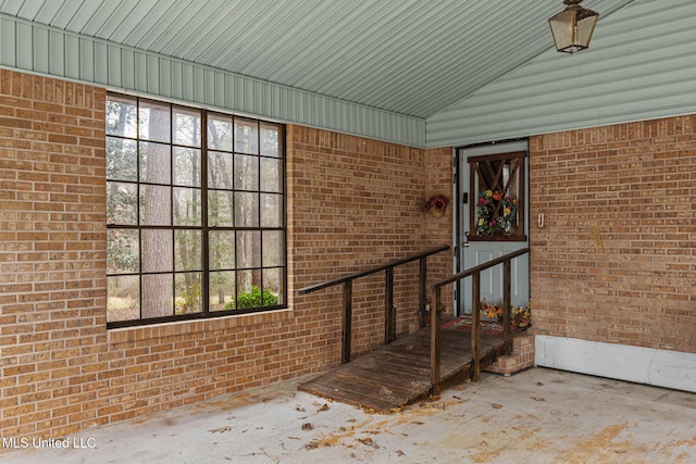 entrance to property featuring brick siding