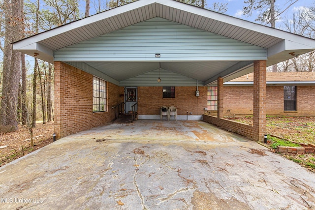 view of patio / terrace with a carport and driveway