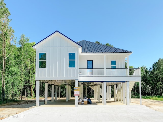 rear view of house with covered porch and a carport