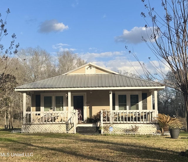 1041 Van Norman, Mccomb, MS 39648 - view of front of property with a porch, a front yard, and metal roof